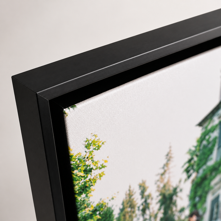 The image is a close-up of a framed print depicting a serene landscape with trees and a building in the background.